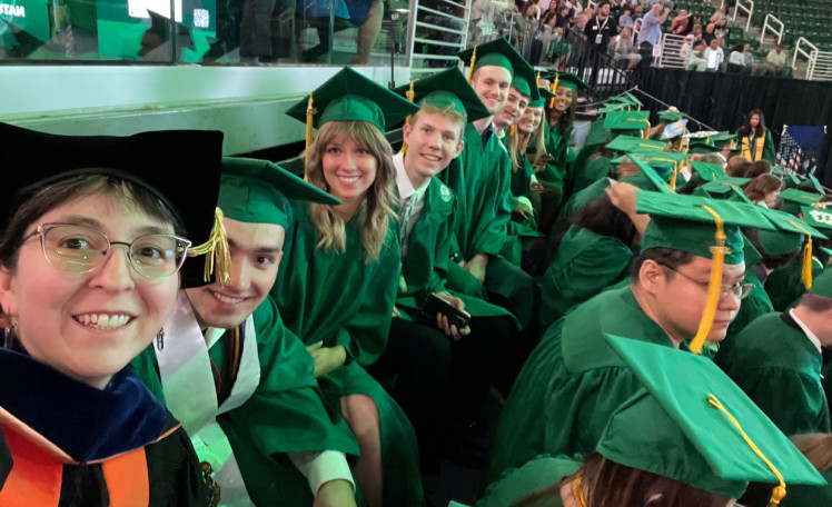 students at graduation wearing caps and gowns