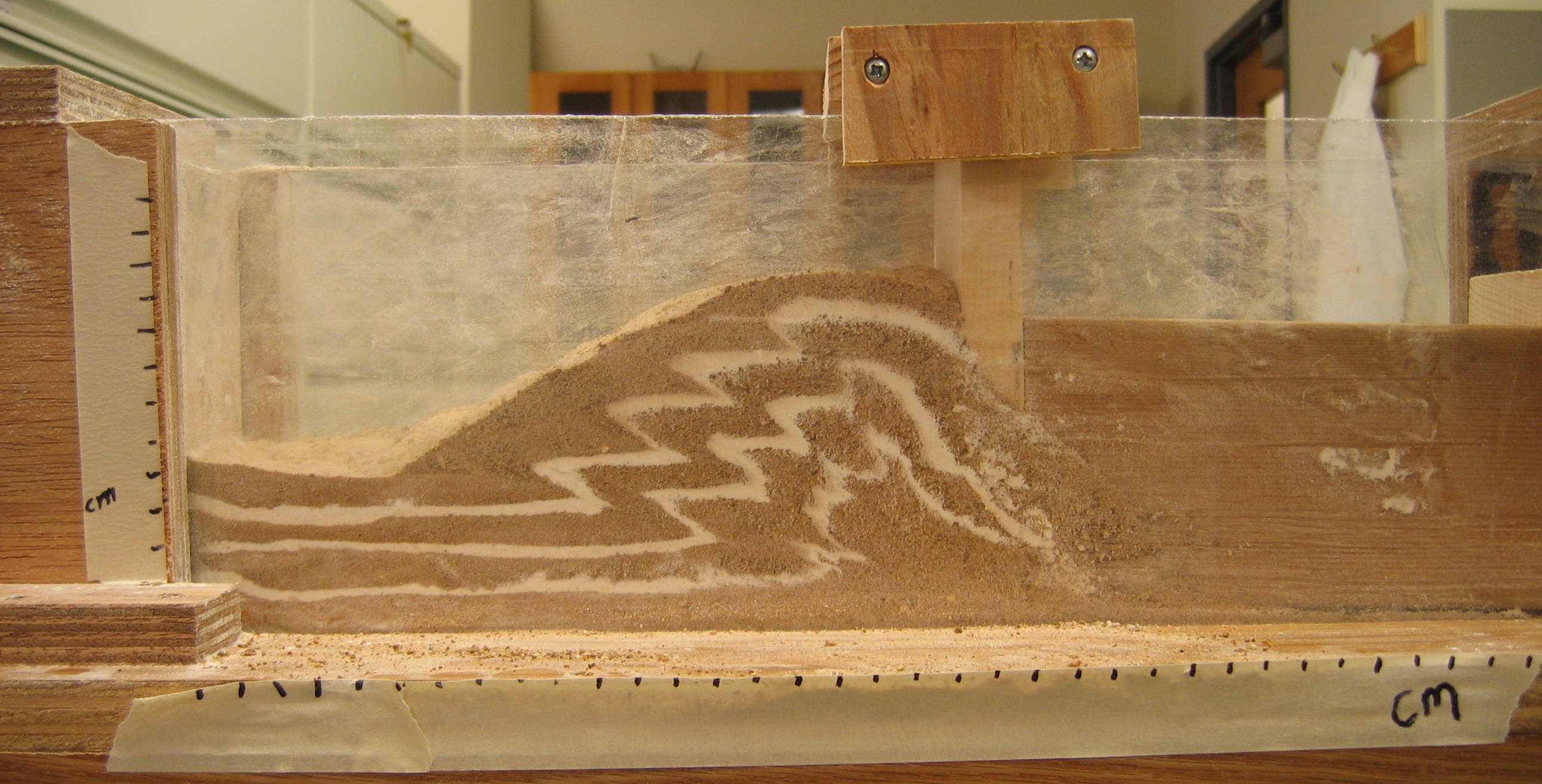 Layers of sand and flour demonstrating folds and faults due to compression